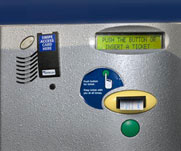 image of parking entrance - big round button and ticket being dispensed directly above the button